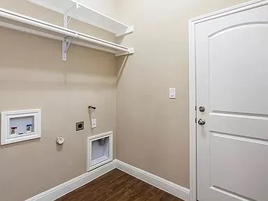 a view of an empty room with wooden floor and closet