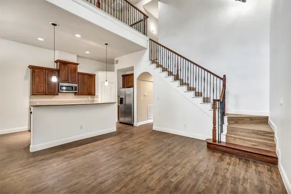 a view of kitchen with wooden floor and electronic appliances
