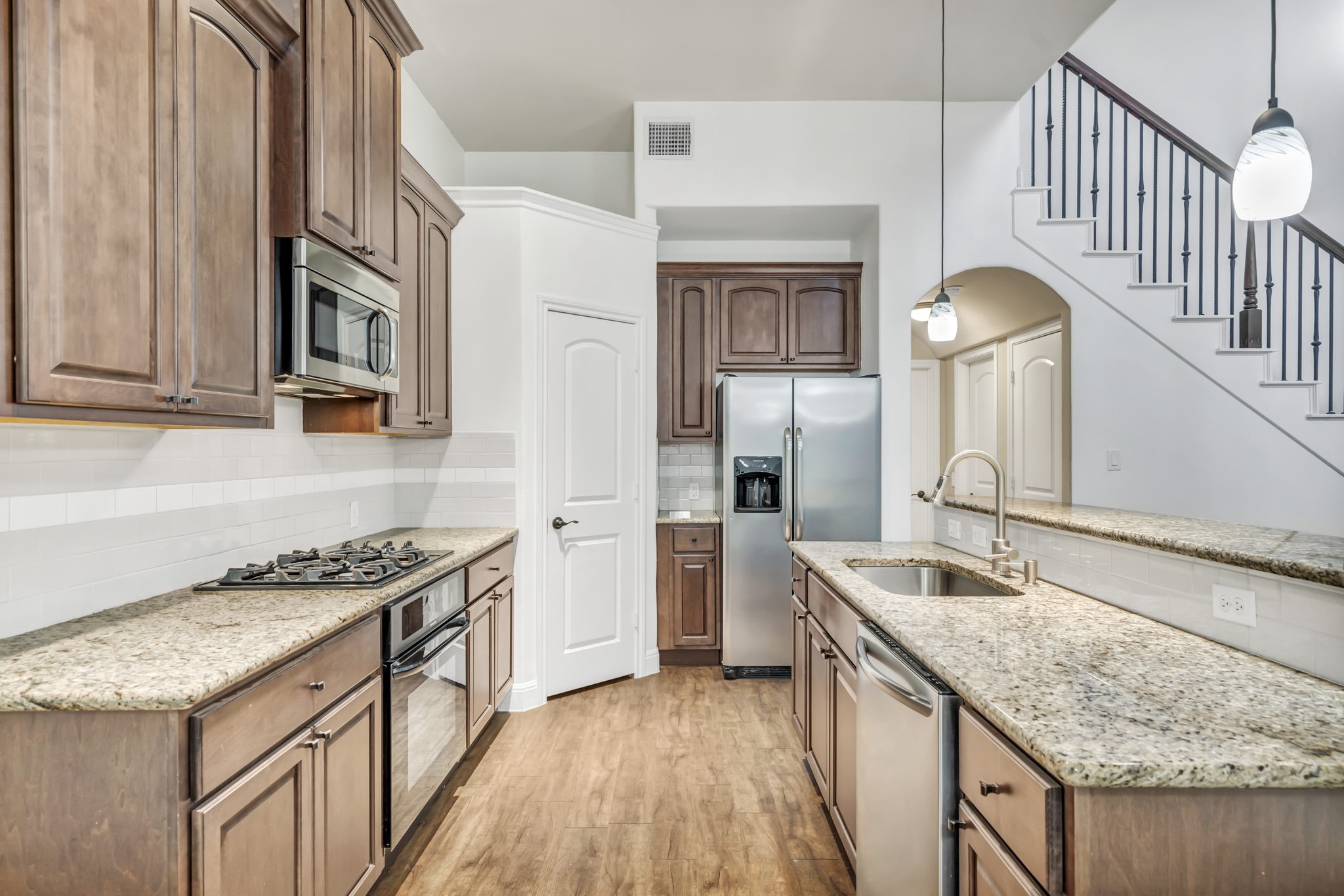 206 Sunrise Ridge Cove Austin, TX 78738 - Photo 5 of 38 a kitchen with stainless steel appliances granite countertop a sink stove and refrigerator