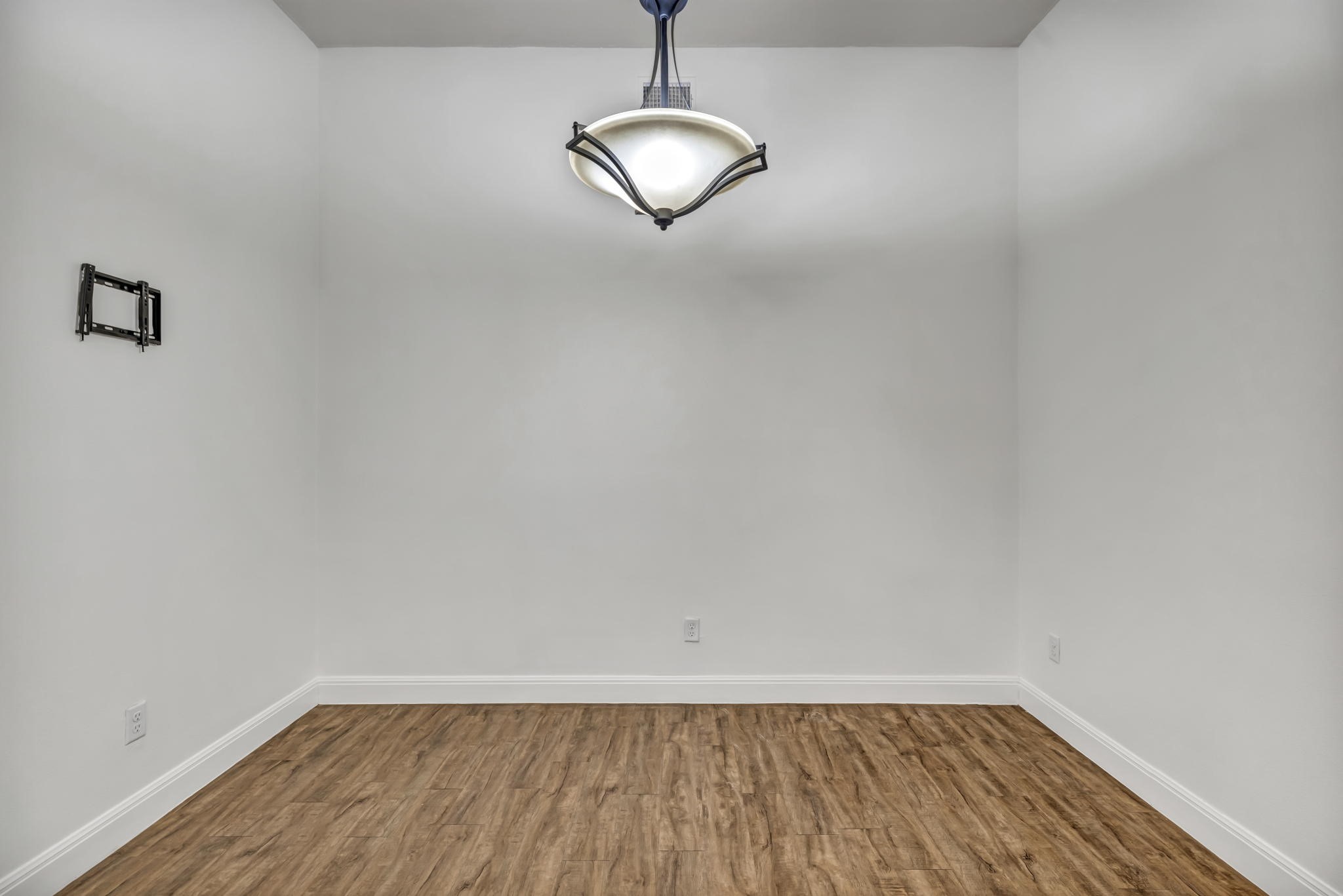 206 Sunrise Ridge Cove Austin, TX 78738 - Photo 7 of 38 a view of an empty room with wooden floor and a window