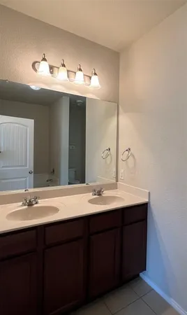 a bathroom with a double vanity sink and a mirror