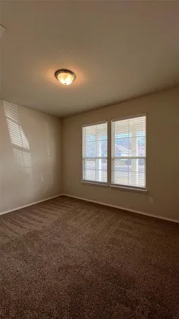 an empty room with a empty space and windows