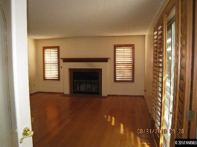 10080 Raccoon Court Reno, NV 89523 - Photo 3 of 8 a view of an empty room with window and fire place