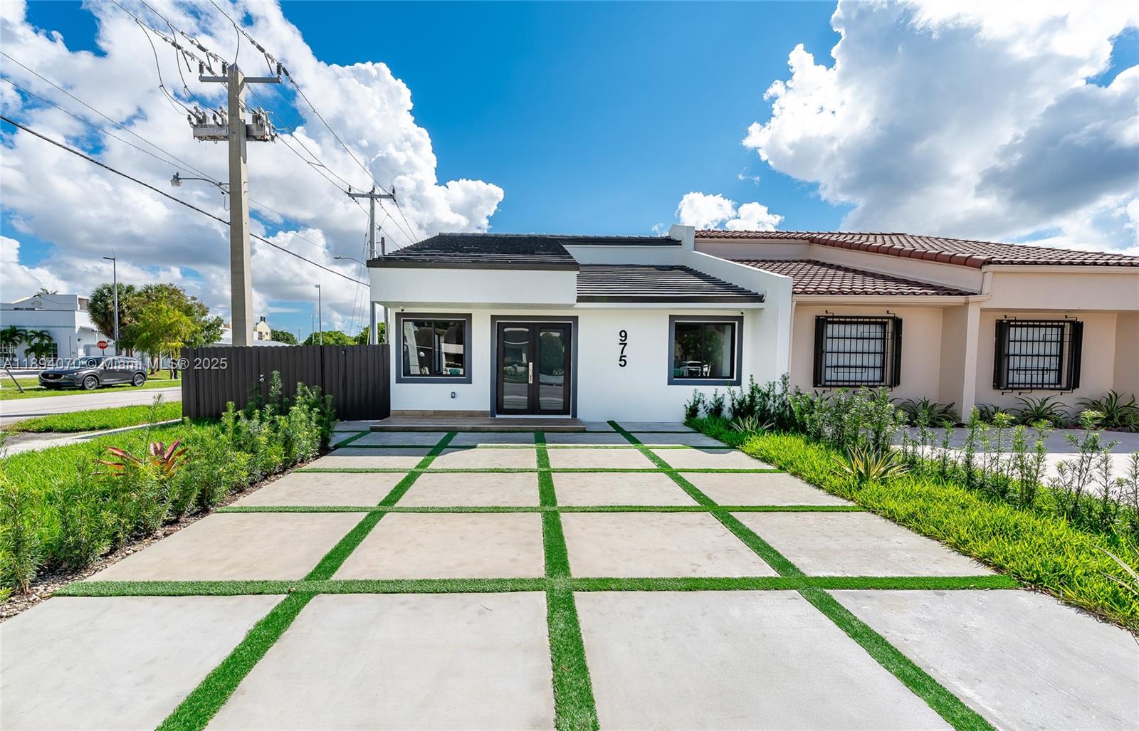 975 Southwest 89th Avenue Miami, FL 33174 - Photo 1 of 17 a front view of a house with a garden