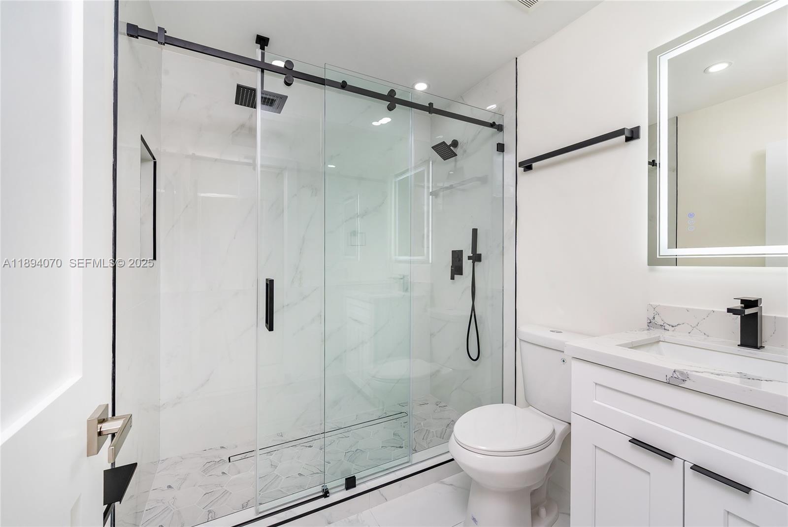 975 Southwest 89th Avenue Miami, FL 33174 - Photo 11 of 17 a bathroom with a granite countertop toilet sink and shower