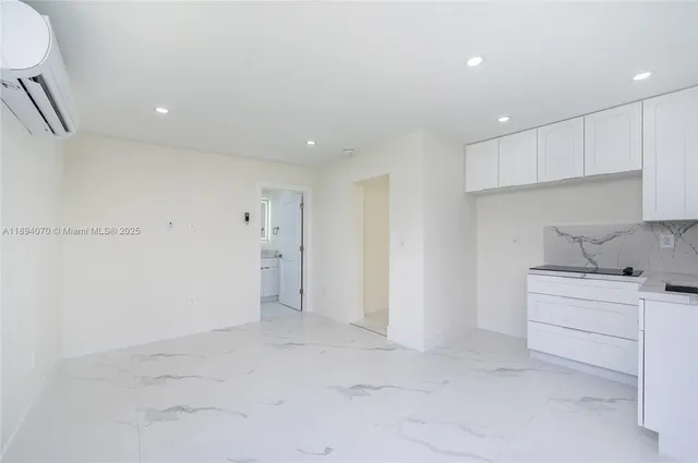 a view of a kitchen with white cabinets