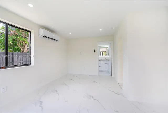 an empty room with windows and entrance