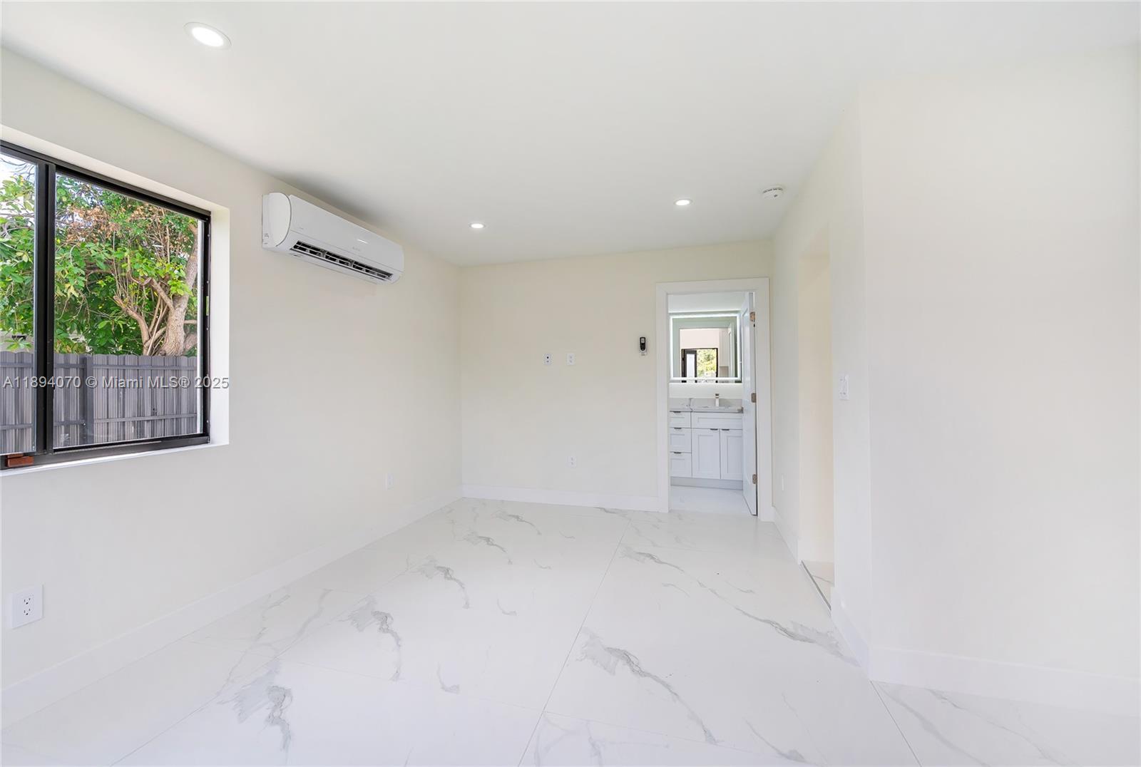 975 Southwest 89th Avenue Miami, FL 33174 - Photo 16 of 17 an empty room with windows and entrance