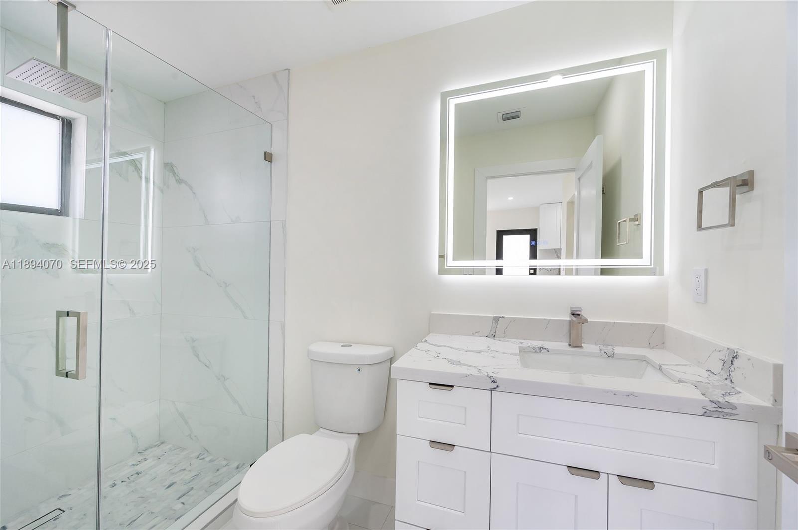 975 Southwest 89th Avenue Miami, FL 33174 - Photo 17 of 17 a bathroom with a sink toilet vanity and shower