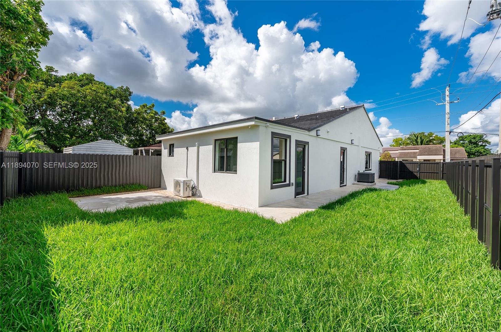 975 Southwest 89th Avenue Miami, FL 33174 - Photo 2 of 17 a view of a white house with a big yard and a large tree