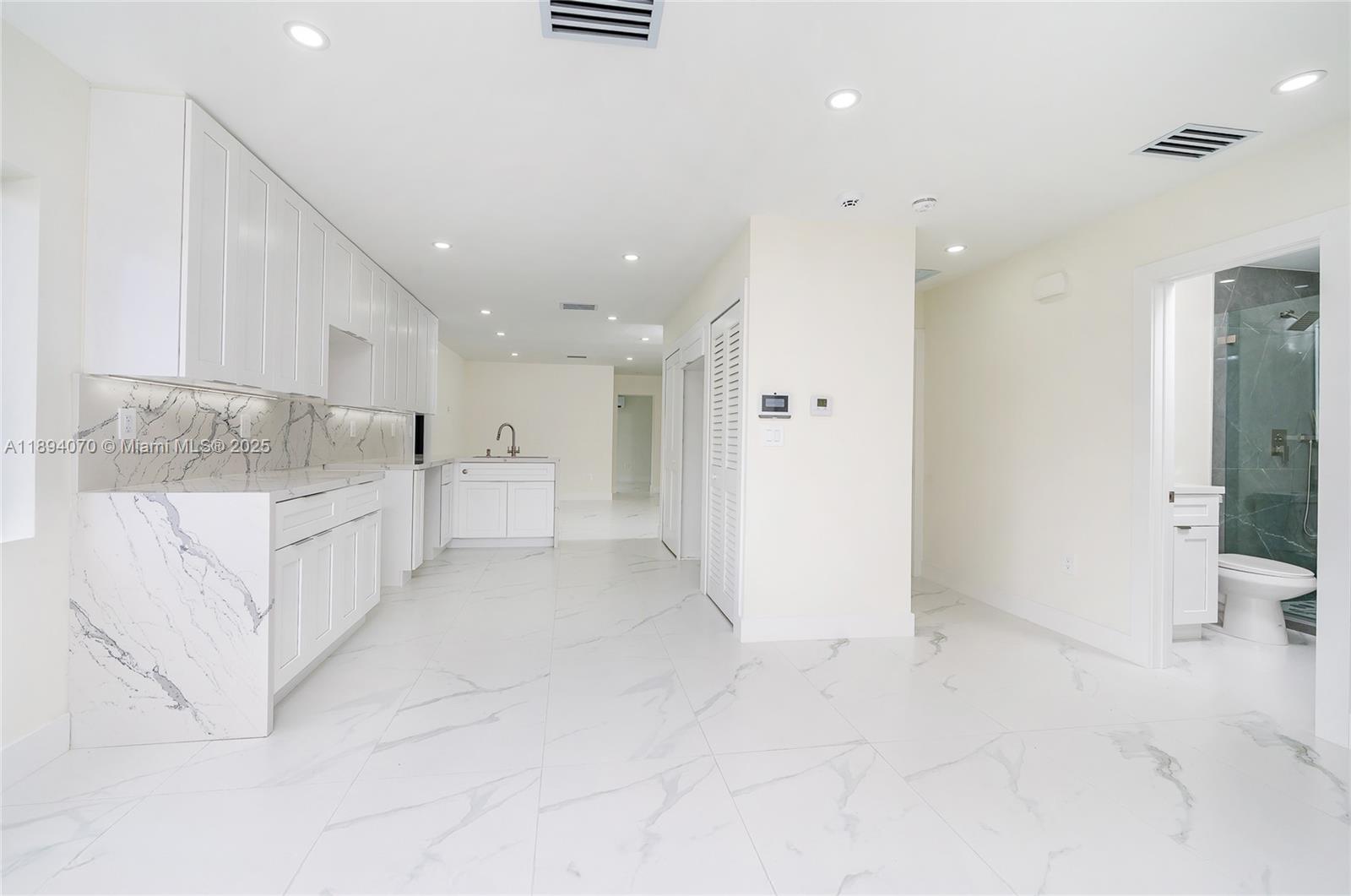 975 Southwest 89th Avenue Miami, FL 33174 - Photo 3 of 17 a view of kitchen with white cabinets and sink