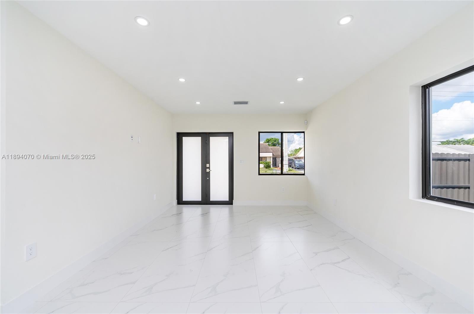 975 Southwest 89th Avenue Miami, FL 33174 - Photo 5 of 17 an empty room with windows