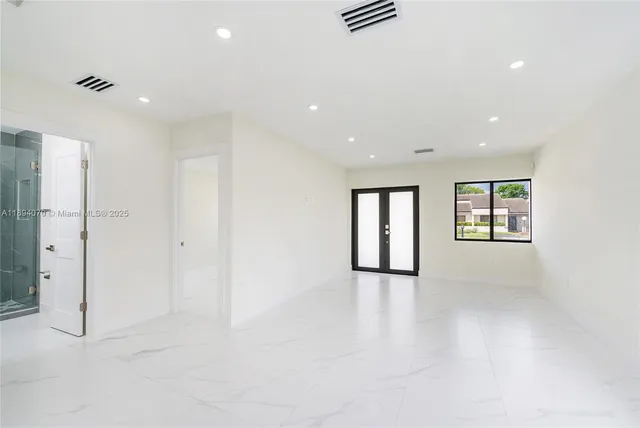 an empty room with windows and closet