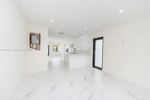 a view of kitchen with furniture and refrigerator