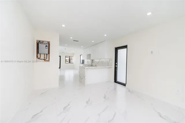 a view of kitchen with furniture and refrigerator