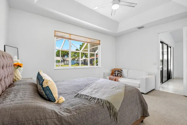 an aerial view of a house with a swimming pool and outdoor seating