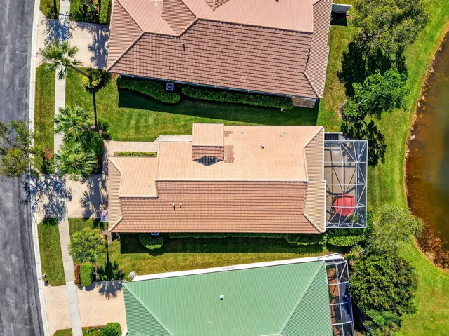 an aerial view of residential houses with outdoor space and swimming pool