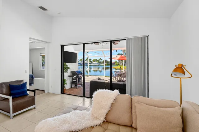 a view of backyard with swimming pool and outdoor seating