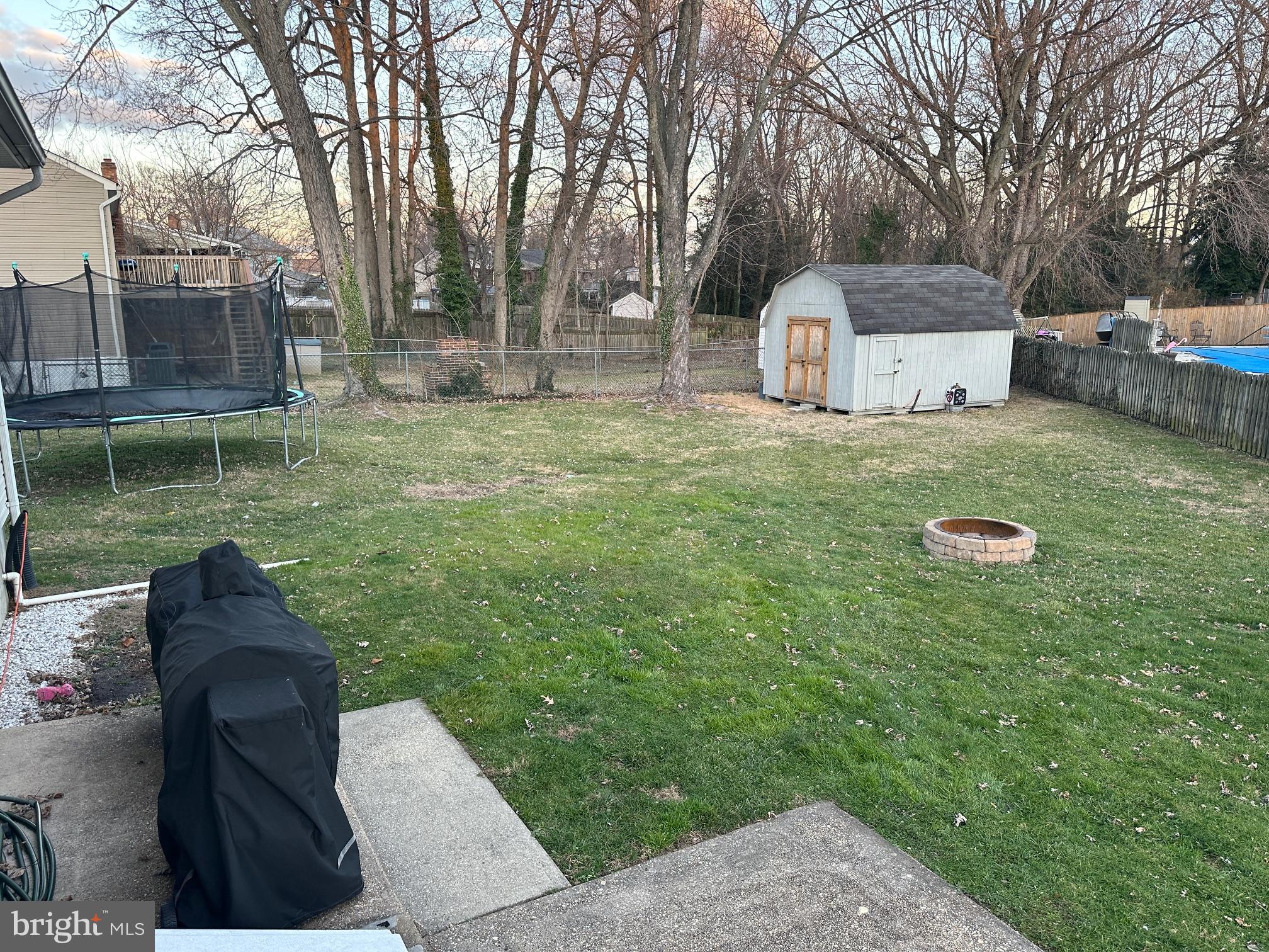 231 Inlet Drive Pasadena, MD 21122 - Photo 26 of 38 Expansive fenced rear yard w/firepit & shed, pat.
