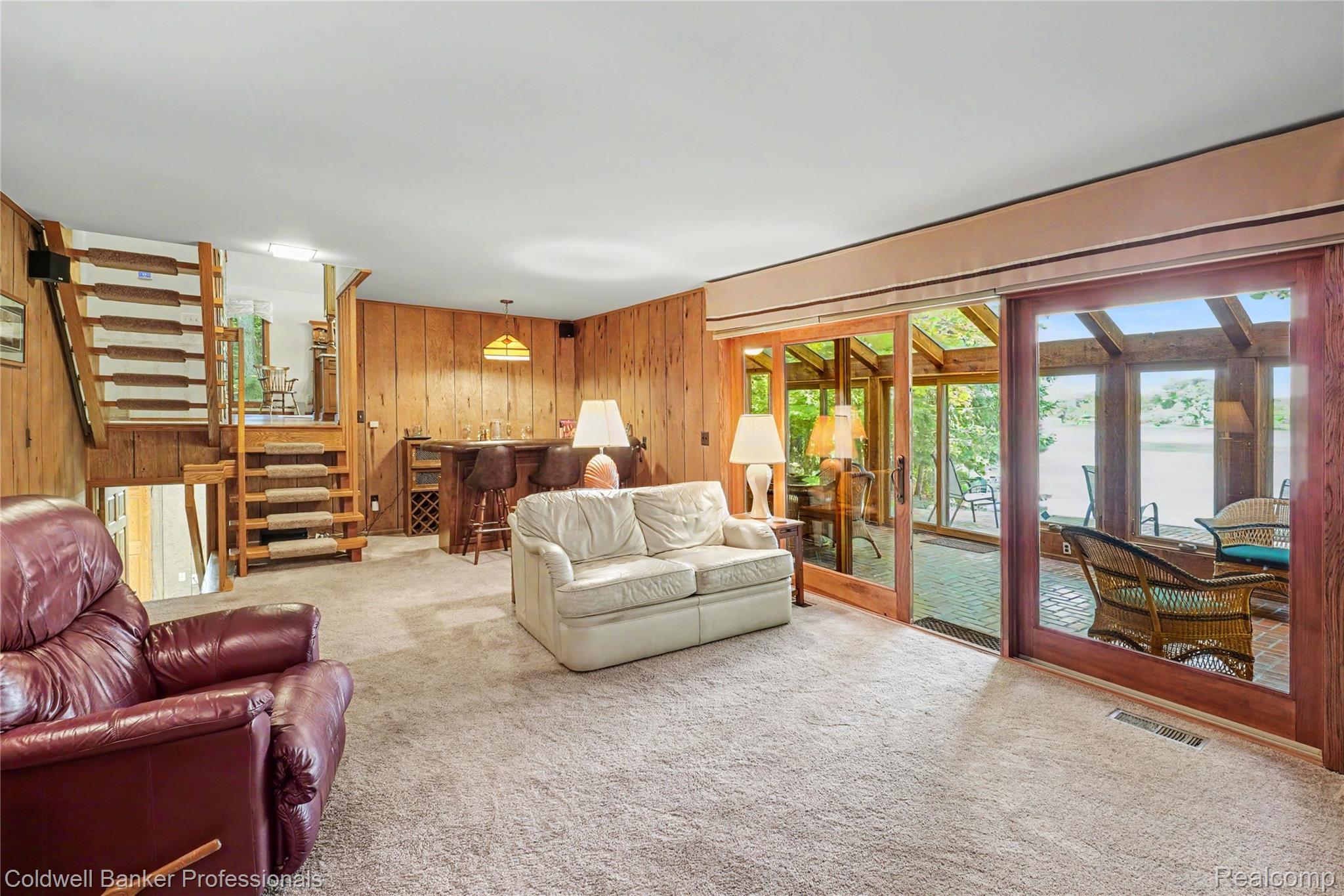 3583 Mitchell Road Metamora, MI 48455 - Photo 21 of 58 Spacious living area featuring light-colored carpeting and wood paneling
