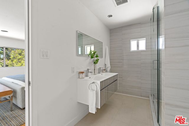 a bathroom with a sink a mirror and a toilet