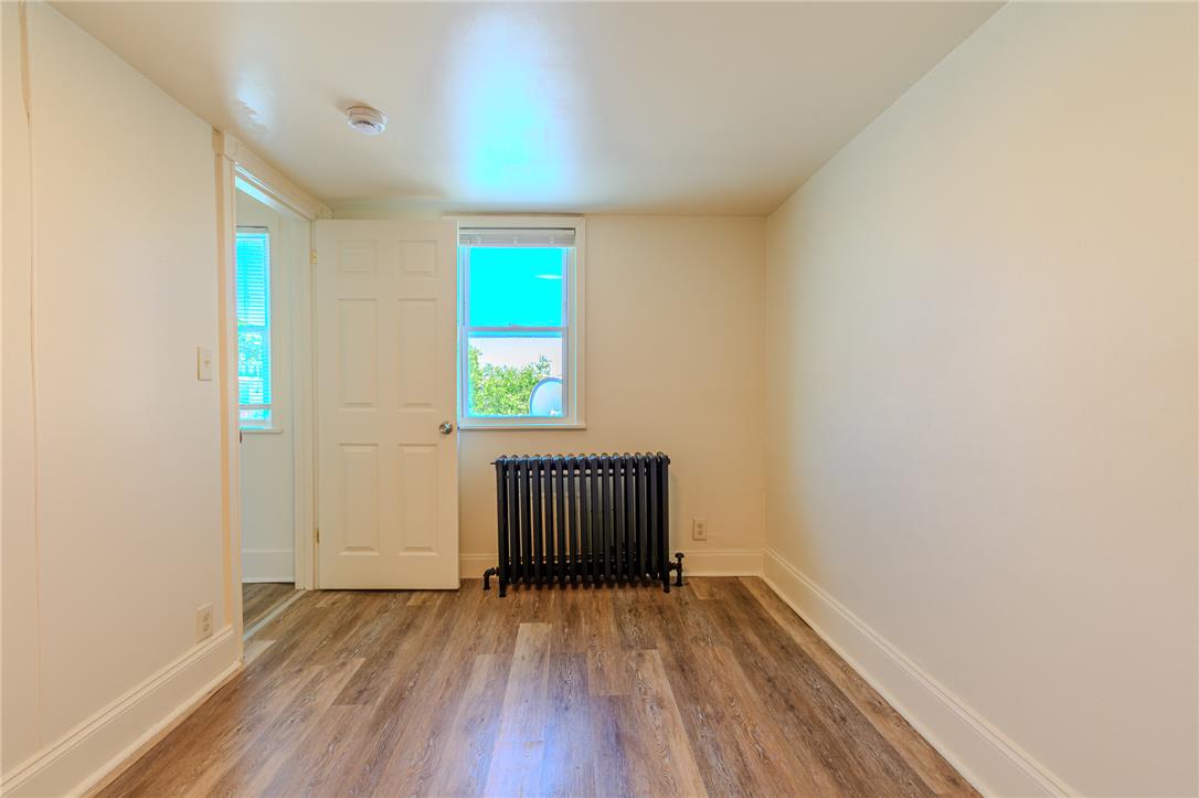 820 North 5th Street Allentown, PA 18102 - Photo 33 of 39 A well-lit room showcases durable laminate flooring, ideal for a flexible living or sleeping area.
