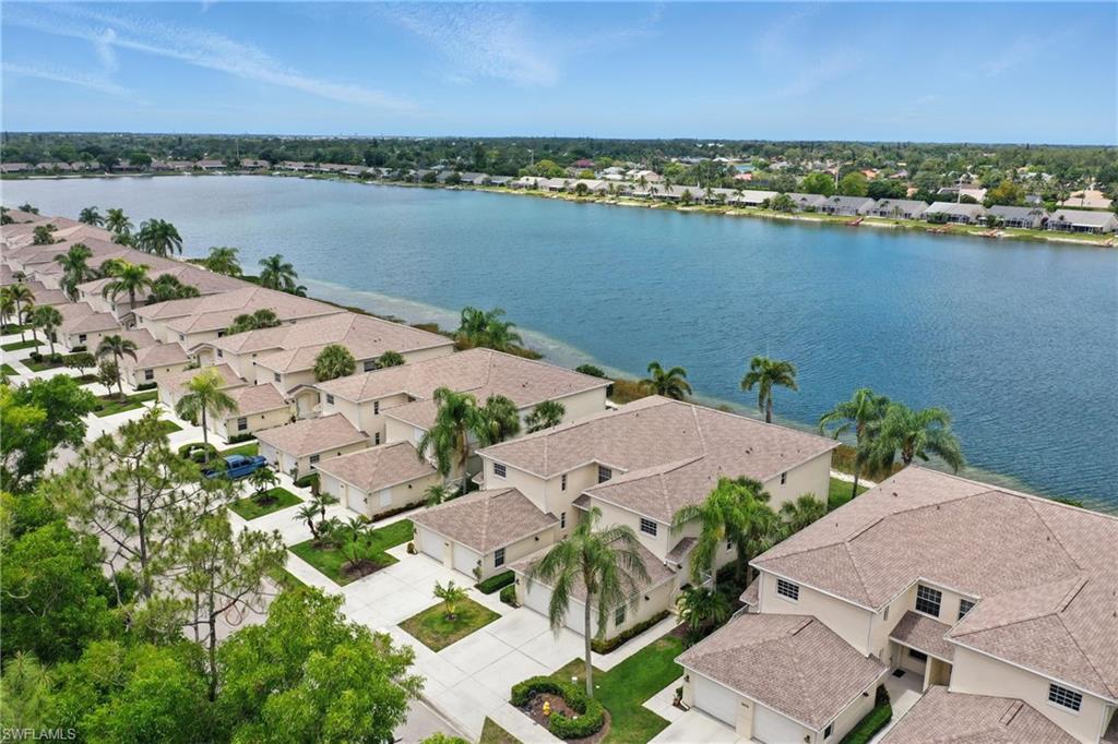 3460 West Crown Pointe Boulevard, Unit 101 Naples, FL 34112 - Photo 1 of 43 an aerial view of a residential houses with outdoor space and lake view