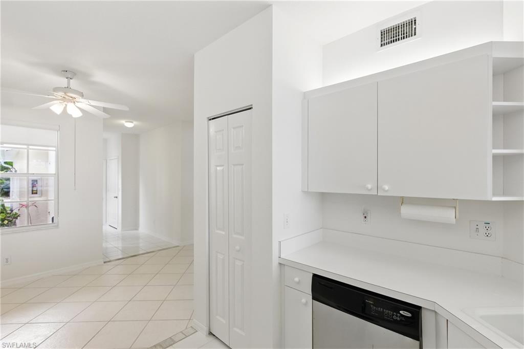 3460 West Crown Pointe Boulevard, Unit 101 Naples, FL 34112 - Photo 11 of 43 a view of cabinets and window