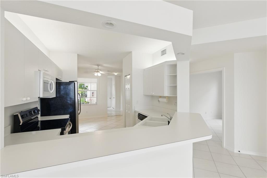3460 West Crown Pointe Boulevard, Unit 101 Naples, FL 34112 - Photo 12 of 43 a bathroom with a bathtub and a sink