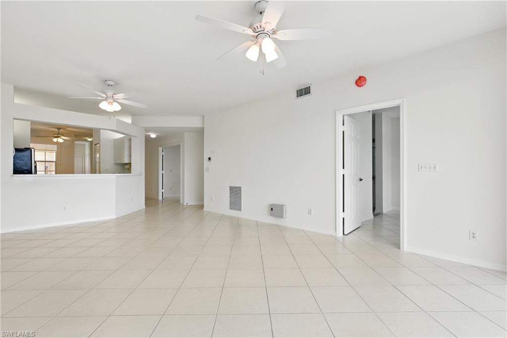 3460 West Crown Pointe Boulevard, Unit 101 Naples, FL 34112 - Photo 15 of 43 wooden floor in an empty room with a window