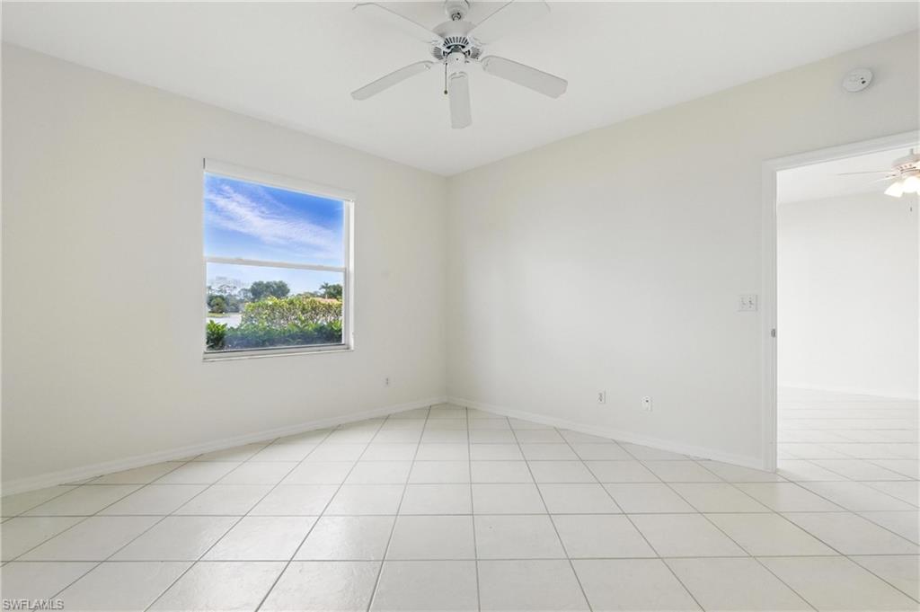 3460 West Crown Pointe Boulevard, Unit 101 Naples, FL 34112 - Photo 19 of 43 an empty room with windows