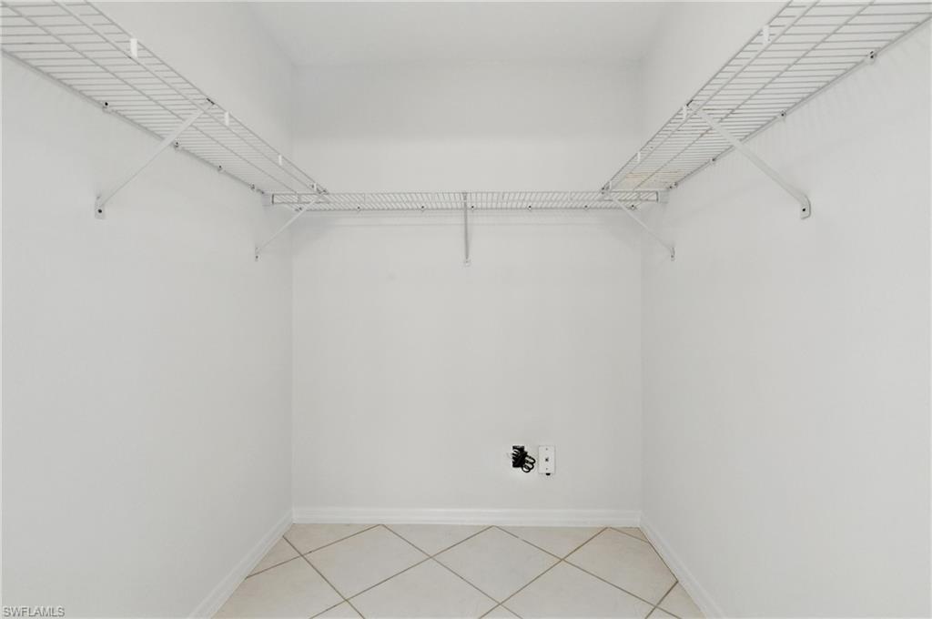 3460 West Crown Pointe Boulevard, Unit 101 Naples, FL 34112 - Photo 24 of 43 a view of an empty walk in closet