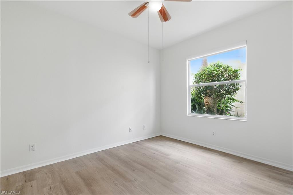 3460 West Crown Pointe Boulevard, Unit 101 Naples, FL 34112 - Photo 25 of 43 an empty room with a window