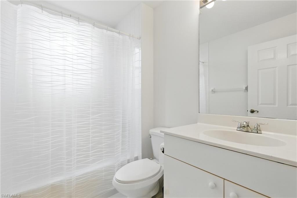 3460 West Crown Pointe Boulevard, Unit 101 Naples, FL 34112 - Photo 29 of 43 a bathroom with a sink a toilet and shower