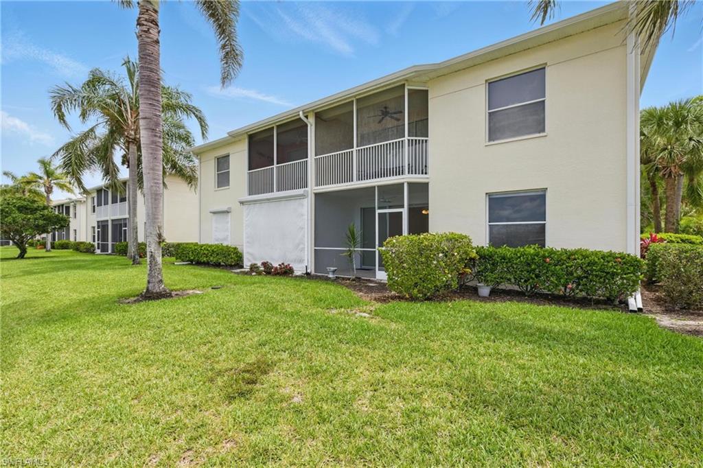 3460 West Crown Pointe Boulevard, Unit 101 Naples, FL 34112 - Photo 35 of 43 a view of a house with a yard