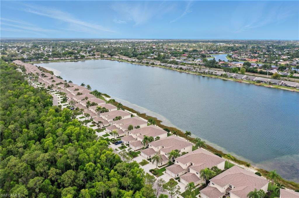 3460 West Crown Pointe Boulevard, Unit 101 Naples, FL 34112 - Photo 37 of 43 an aerial view of a residential houses with outdoor space and ocean view