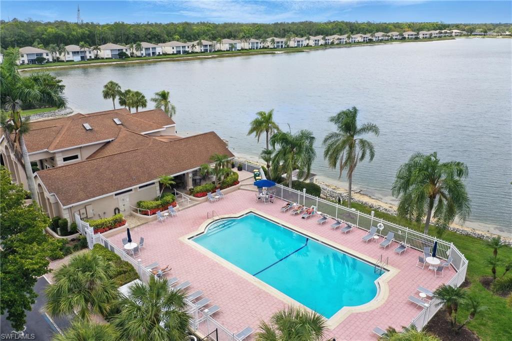 3460 West Crown Pointe Boulevard, Unit 101 Naples, FL 34112 - Photo 41 of 43 an aerial view of residential houses with outdoor space and lake view