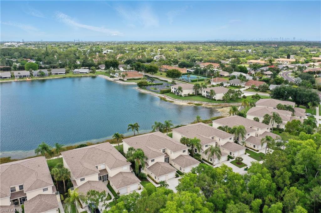 3460 West Crown Pointe Boulevard, Unit 101 Naples, FL 34112 - Photo 43 of 43 an aerial view of residential houses with outdoor space and river