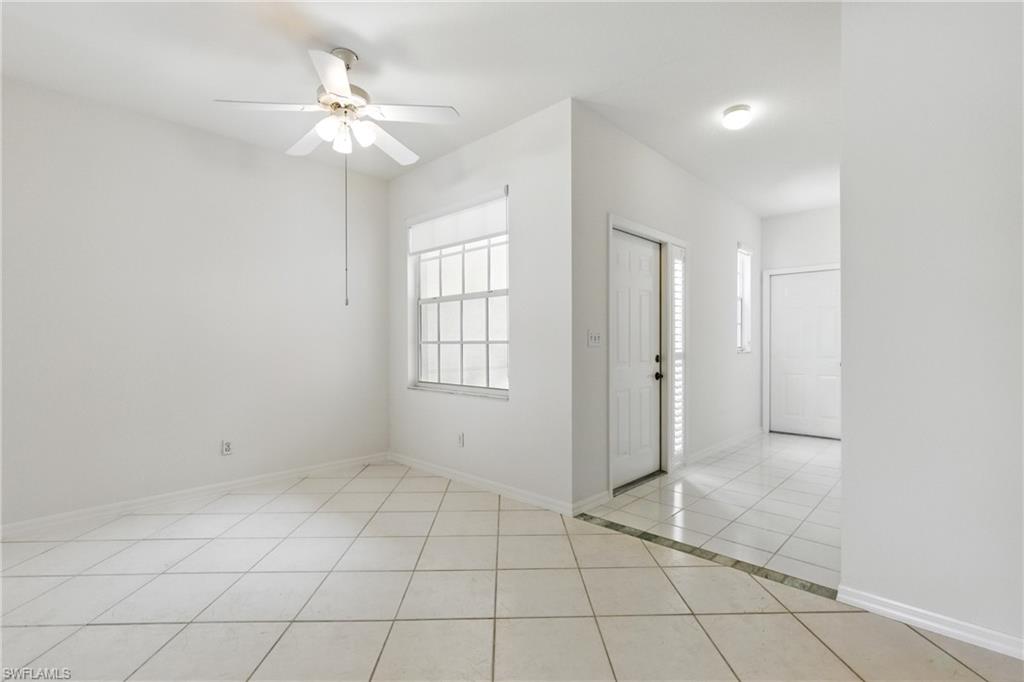 3460 West Crown Pointe Boulevard, Unit 101 Naples, FL 34112 - Photo 6 of 43 an empty room with windows and fan