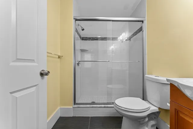 a bathroom with a toilet and a shower