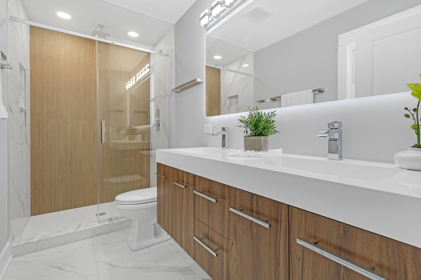 1814 Oakton Street Park Ridge, IL 60068 - Photo 18 of 30 a bathroom with a double vanity sink toilet and shower