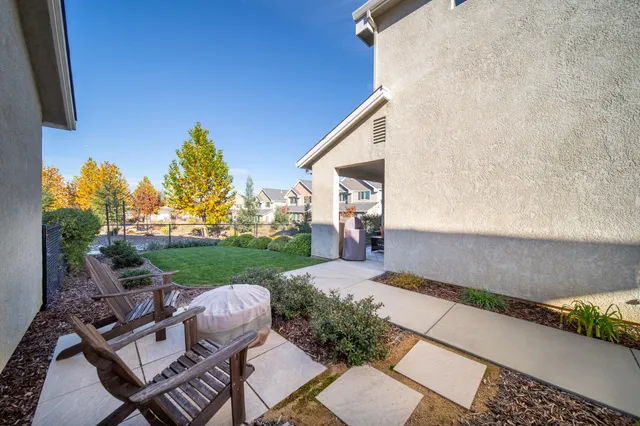 a view of backyard of house with outdoor seating