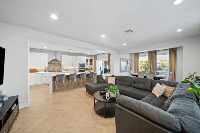 a living room with furniture and view of kitchen