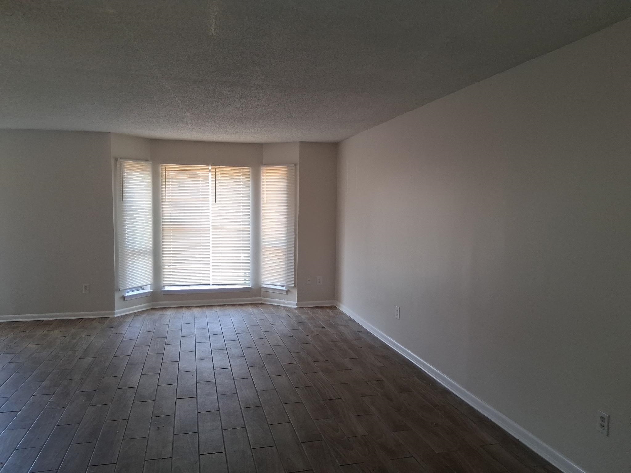 5265 Chatfield Drive, Unit 5265 Memphis, TN 38116 - Photo 1 of 9 an empty room with wooden floor and windows
