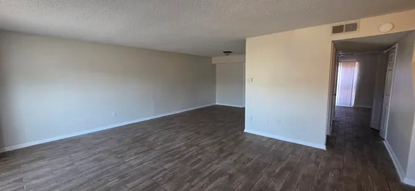 an empty room with wooden floor and closet
