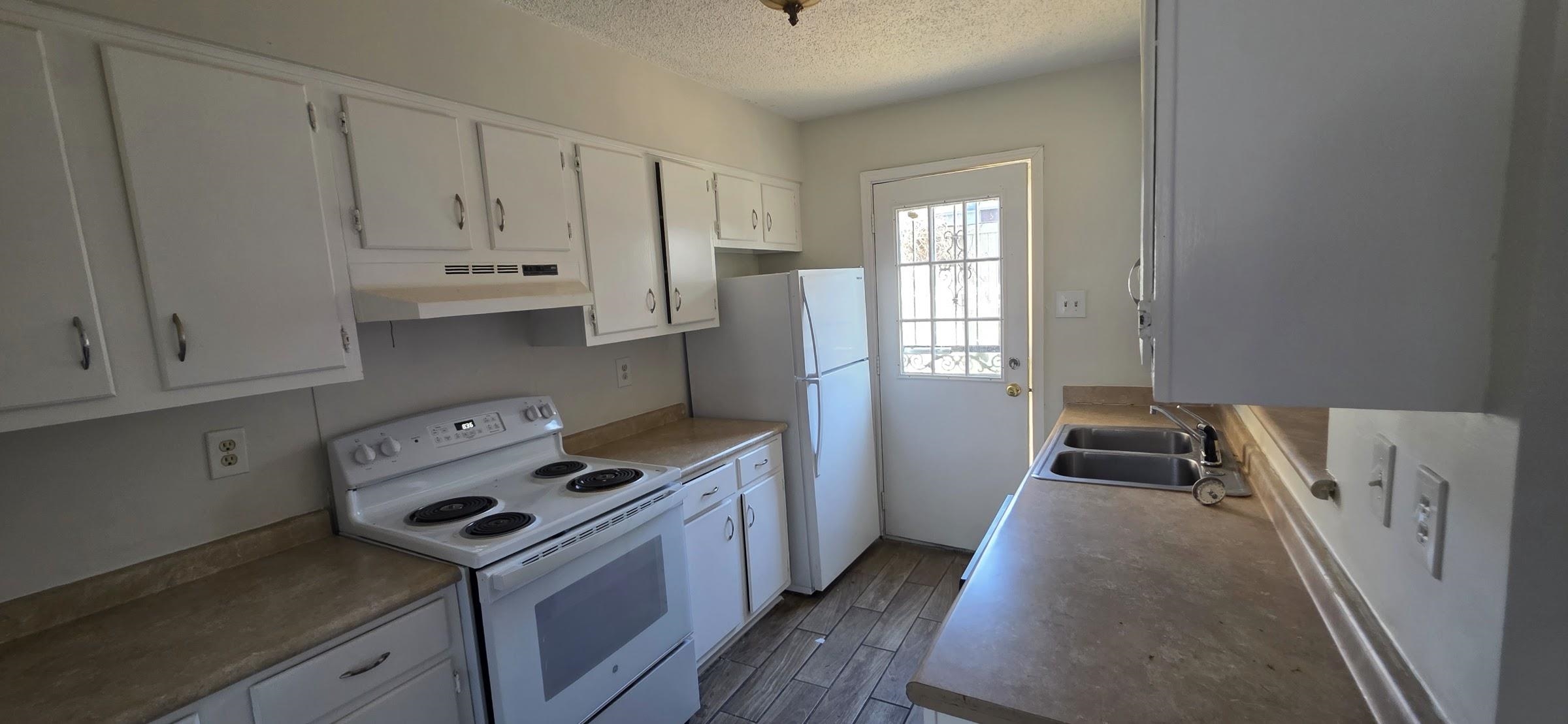5265 Chatfield Drive, Unit 5265 Memphis, TN 38116 - Photo 6 of 9 a kitchen with granite countertop a sink a stove and refrigerator