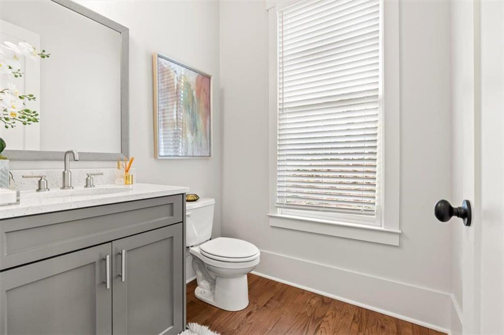 1049 Endeavour Court Marietta, GA 30064 - Photo 19 of 39 a bathroom with a toilet sink vanity and mirror
