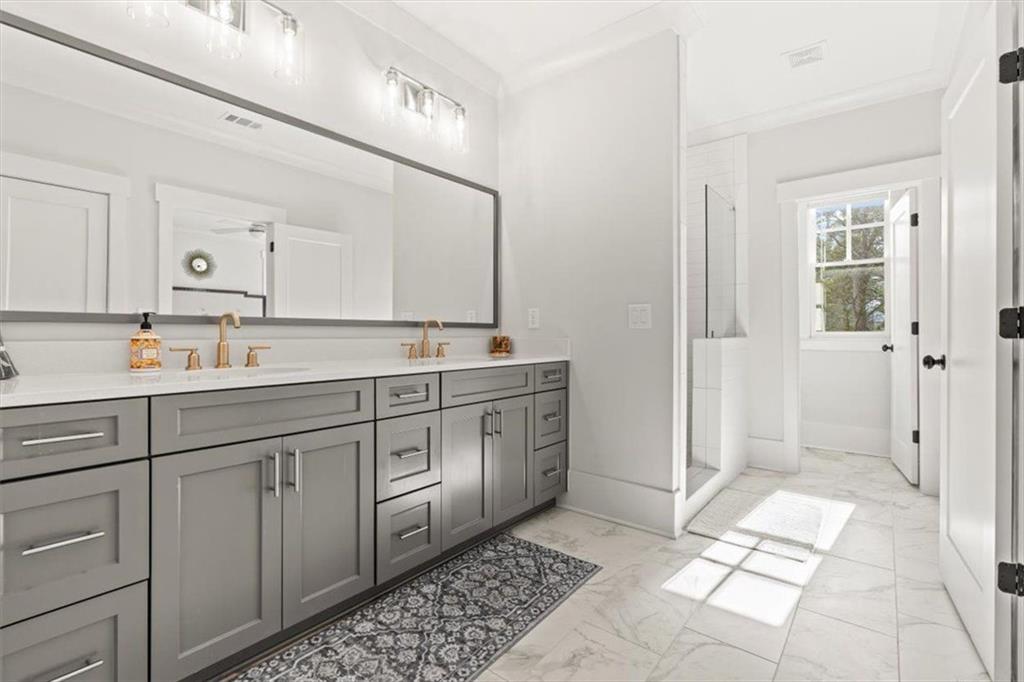 1049 Endeavour Court Marietta, GA 30064 - Photo 23 of 39 a spacious bathroom with double vanity and a mirror