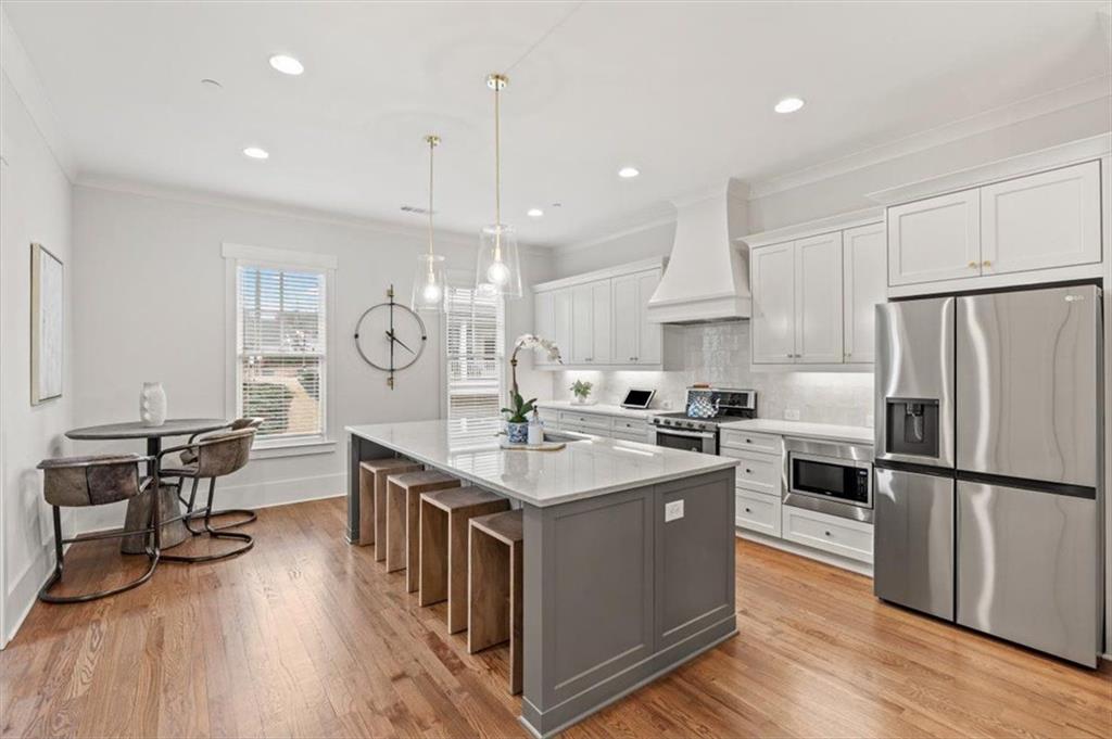 1049 Endeavour Court Marietta, GA 30064 - Photo 10 of 39 a kitchen with stainless steel appliances granite countertop a sink a stove and a refrigerator