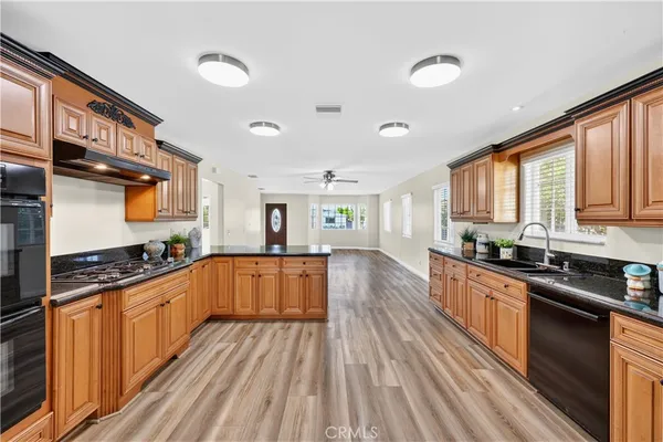 a bathroom with a granite countertop sink a large mirror and shower